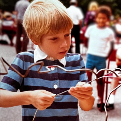 A photograph of Peter Jorgensen as a young boy tackling the buzz wire game